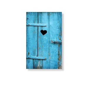 May include: A weathered blue wooden door with a heart-shaped cutout and a metal latch. The door is made of planks and has a rustic, vintage look.