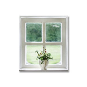 May include: A white window with a single pane of glass on each side and two panes of glass on the bottom. A white ceramic vase with green plants and white flowers sits on the windowsill.
