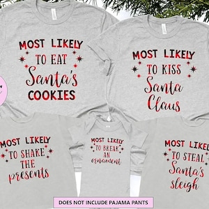 May include: A collection of five light gray t-shirts and a baby bodysuit featuring red and black plaid text. The shirts display phrases including Most Likely To Eat Santa's Cookies, To Kiss Santa Claus, To Shake The Presents, To Break An Ornament, and To Steal Santa's Sleigh, accented with small red star graphics.
