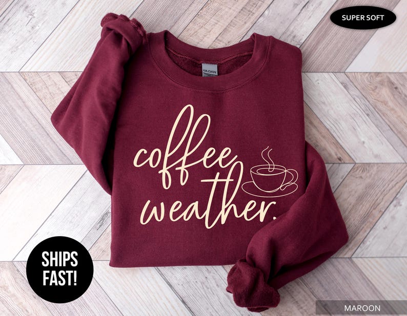 May include: Maroon crewneck sweatshirt with the words "coffee weather" in a cursive font and a coffee cup graphic. The sweatshirt is labeled "Super Soft".