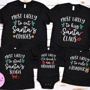 May include: A set of five black t-shirts and one black baby bodysuit featuring white text and Christmas-themed graphics. The shirts display phrases including Most Likely to eat Santa's cookies, kiss Santa Claus, steal Santa's sleigh, break an ornament, and ride a reindeer.