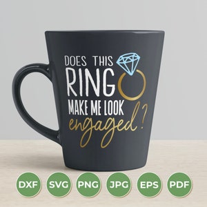 May include: A black coffee mug with a white design that says "Does this ring make me look engaged?" with a gold ring and blue diamond illustration.