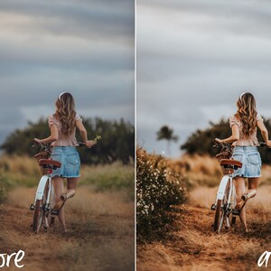 May include: A woman in a pink shirt and denim skirt rides a white bicycle down a dirt path. The path is lined with green grass and wildflowers. The sky is overcast and gray.