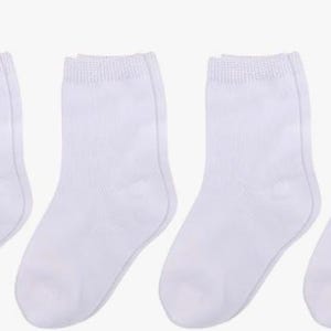 May include: A collection of white ankle socks, arranged in a row. The socks are made of a soft, knitted material and have a ribbed cuff at the top. The socks are a solid white color.