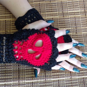 May include: Black and red crochet fingerless gloves with a skull design. The gloves are made with a lacy stitch and have a red skull pattern on the back of the hand.