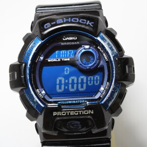 May include: Black and blue G-Shock digital watch with a blue digital display showing 0:00:00. The watch has multiple buttons and features the Casio and G-Shock logos. The watch is designed for protection.