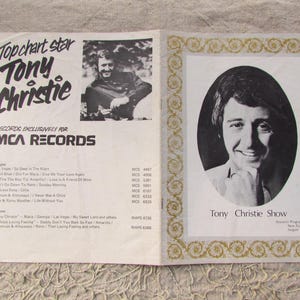 May include: An open booklet featuring Tony Christie, a top chart star. The left side has text and a black and white photo. The right side has a portrait of Tony Christie in an oval frame with decorative gold trim.