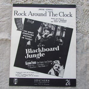 May include: A vintage sheet music cover for Rock Around The Clock featuring black and white graphics, text promoting the film Blackboard Jungle, starring Glenn Ford, and credits for Max C. Freedman and Jimmy De Knight, published by Southern Music.