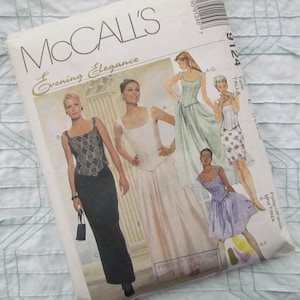 May include: A vintage McCall's sewing pattern titled "Evening Elegance." The pattern features illustrations of evening gowns and dresses in various styles. The cover is white with images of women wearing the dresses.