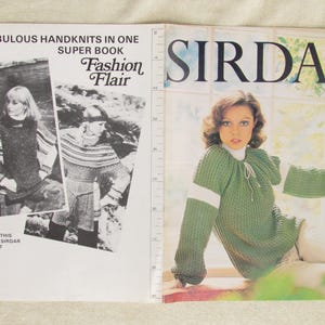 May include: A vintage knitting pattern book. The left page has text: "36 Fabulous Handknits in One Super Book Fashion Flair." The right page shows a woman in a green knitted sweater. The word "Sirdar" is displayed prominently.