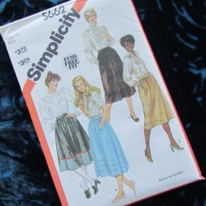 May include: A Simplicity sewing pattern, number 5662, showing illustrations of women in blouses and skirts. The envelope is white with red and black text. The words "Fuss Free Fit" are also printed on the envelope.