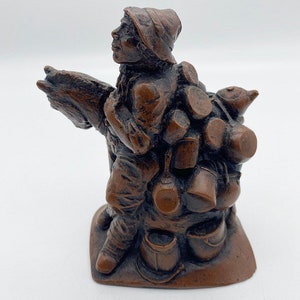 Vintage resin peddler figurine, small trader figure, vendor statue