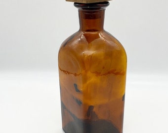 Vintage liquor amber bottle with wooden stopper