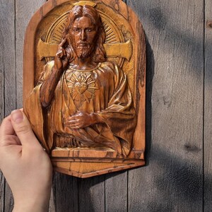 In this photo you can see how the carved plaque looks in your hand. The size on the photo is 10 inches.