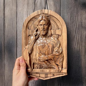 In this photo you can see how the carved plaque looks in your hand. The size on the photo is 10 inches.