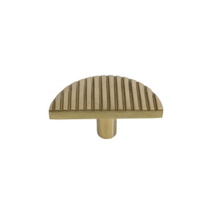 May include: A gold-toned half-round cabinet knob with a ridged design. The knob has a cylindrical base.