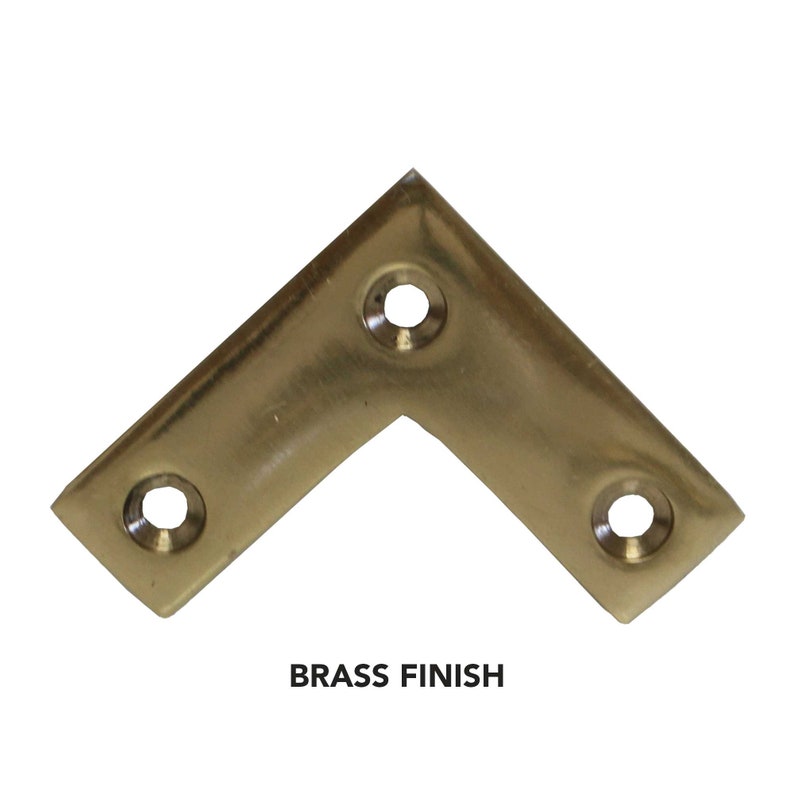 May include: Brass corner brace with four screw holes.  The brace is a light gold color.  BRASS FINISH is written below the brace.