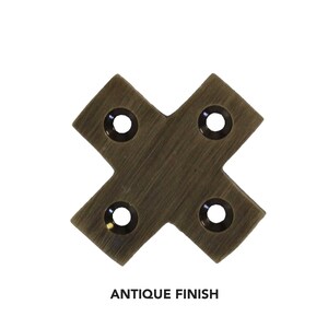 May include: Antique brass corner brace with four holes. The brace is in the shape of an 'X' and has a brushed finish.