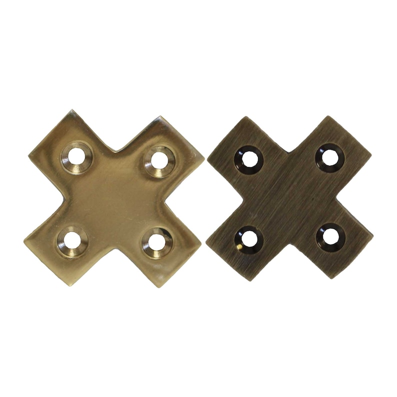 May include: Two brass corner brackets, one with a polished finish and the other with a brushed finish. Each bracket has four holes for attaching to a surface.