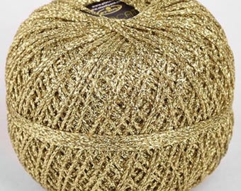 May include: A ball of gold metallic yarn with a label that says "DMC Natura Just Cotton".