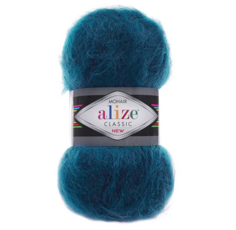 May include: A teal-colored ball of Alize Mohair Classic yarn. The yarn is wrapped with a black and silver label that reads "MOHAIR alize CLASSIC NEW". The yarn appears soft and fluffy, ideal for knitting or crocheting projects.