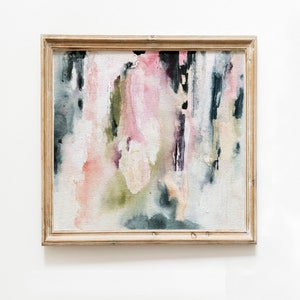 May include: Abstract painting in a wooden frame with shades of pink, green, and black. The painting has a textured, brushstroke effect.
