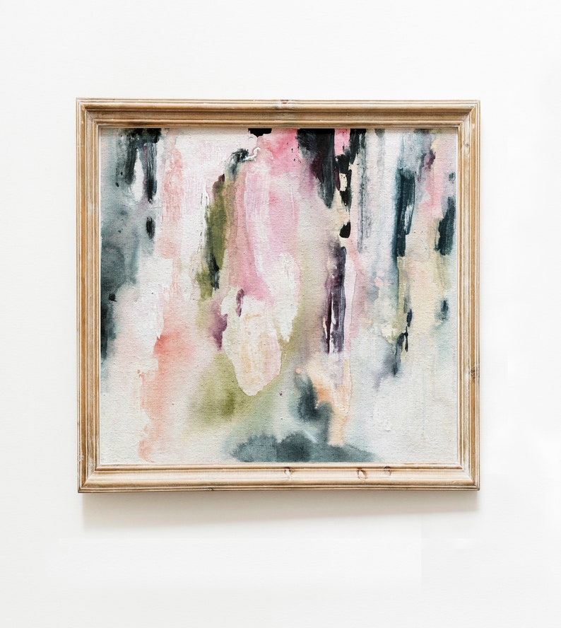 May include: Abstract painting in a wooden frame with shades of pink, green, and black. The painting has a textured, brushstroke effect.