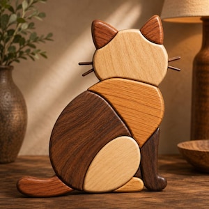 May include: A decorative cat figurine crafted from multiple pieces of wood in varying shades of brown, tan, and cream. The cat is depicted in a seated position with a curved tail, pointed ears, and thin, straight wooden whiskers on each side.