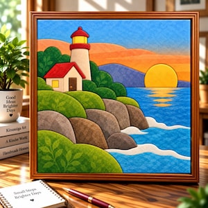 May include: A square framed wall art piece featuring a stylised landscape of a lighthouse on a rocky cliffside overlooking a blue ocean at sunset. The scene includes a bright yellow sun, green hills, and a red-roofed building with a light-coloured tower.