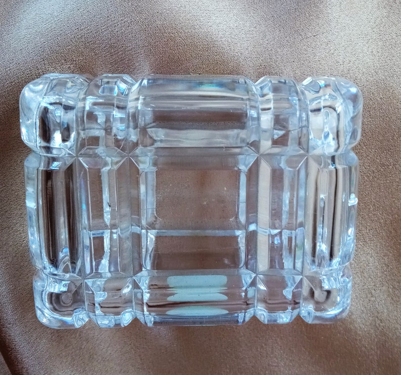 May include: A clear glass box with a geometric pattern. The box is empty and has a rectangular shape.