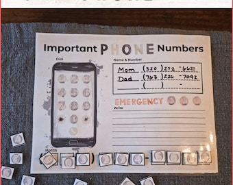 May include: A white and gray learning tool with the words "Important PHONE Numbers" at the top. The tool features a drawing of a phone with numbers, spaces to write names and numbers, and matching number tiles. The text includes "Mom" and "Dad" with phone numbers.