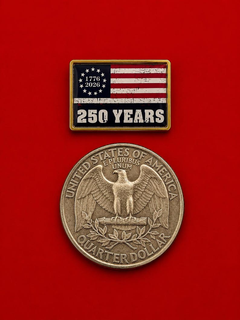 May include: A rectangular gold-toned pin featuring a stylized American flag with the text 1776 2026 and 250 YEARS, positioned above a circular silver-toned United States quarter dollar coin displaying an eagle, the text E PLURIBUS UNUM, and UNITED STATES OF AMERICA.