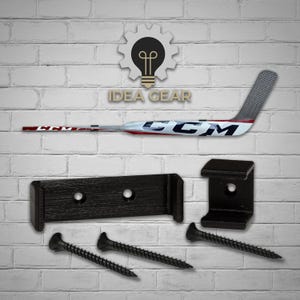 May include: Black hockey stick wall mount with two black brackets, two screws, and a hockey stick with the word "CCM" on it.  The wall mount is designed to hold a hockey stick horizontally on a wall.