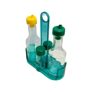 May include: A teal plastic condiment holder with a handle, holding two clear glass bottles with yellow and green lids, and two smaller clear glass bottles with green lids.