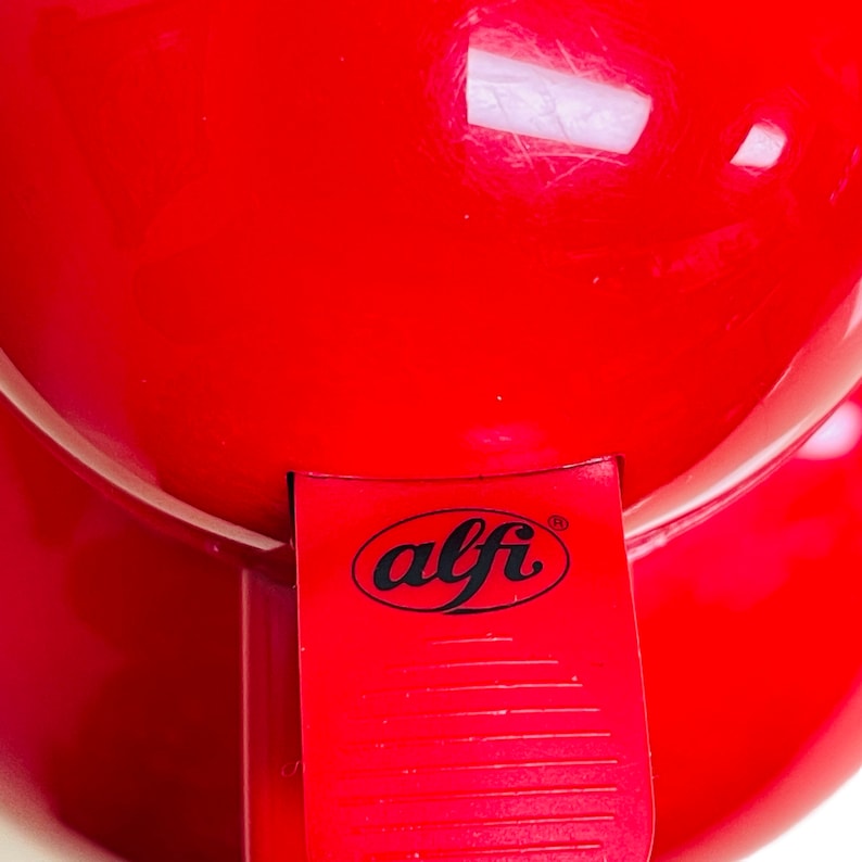 May include: Red electric coffee grinder with a black "alfi" logo on the side.