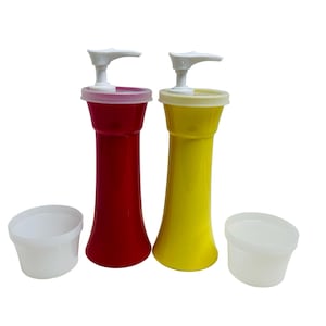 May include: Two condiment dispensers, one red and one yellow, with white pump tops and lids. Two small white plastic containers are also present. The dispensers are designed for easy dispensing of sauces and condiments.