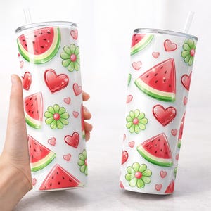 May include: Two white insulated tumblers with a watermelon, heart, and flower pattern. The design features red watermelon slices, red hearts, and green flowers on a white background. Each tumbler has a clear straw.