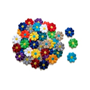 May include: A collection of colourful embroidered flower patches in various colours, including red, blue, green, yellow, and white. The patches are arranged in a circle with a few scattered around the edge.