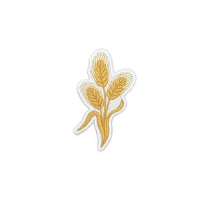 May include: Embroidered patch with a wheat stalk design. The patch has a white border and features three golden wheat heads with detailed stitching. The stems and leaves are also golden, creating a textured, natural appearance.