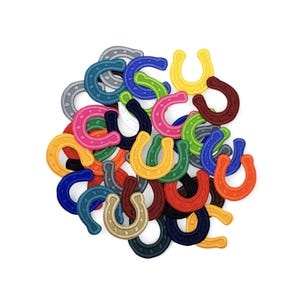 May include: A collection of colorful horseshoe patches in various shades, including blue, green, yellow, pink, and orange. Each patch has a stitched design and is arranged against a white background. These patches are suitable for crafts and DIY projects.