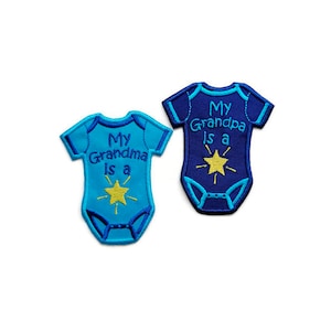 May include: Two blue and navy blue iron-on patches shaped like baby onesies. The blue onesie patch says "My Grandma is a" with a yellow star. The navy blue onesie patch says "My Grandpa is a" with a yellow star.