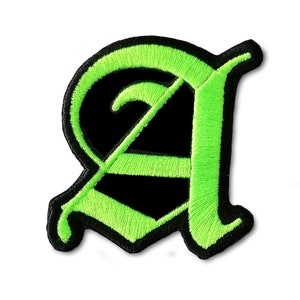May include: A green and black embroidered iron-on patch of the letter "A" in an old English font.