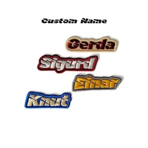 May include: Four embroidered patches with different names: Gerda, Sigurd, Einar, and Knut. The patches are in different colours: beige, red, grey, and blue.
