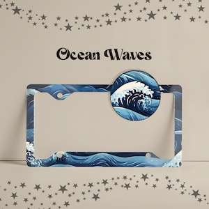 Close-up of a Ocean Waves license plate frame featuring a Japanese-inspired pattern of rolling ocean waves with white foam crests in a deep navy, cobalt blue, and white palette.