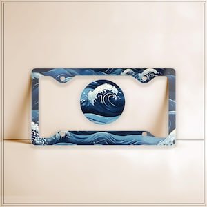 May include: A blue and white license plate frame with a wave design. The frame has a circle in the center with a wave design.