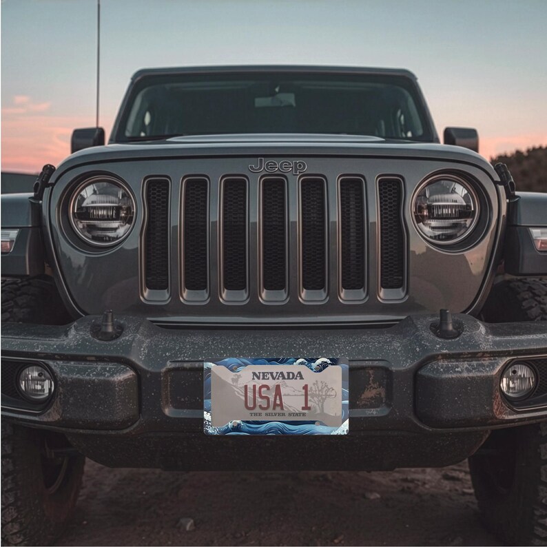 Dimensional measurement guide for the deep navy, cobalt blue, and white wave design car frame, confirming the 12.3 x 6.5 inch size fits standard North American license plates.