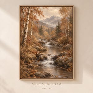 May include: A framed vertical wall art print depicting an autumn forest landscape with a flowing stream, rocky banks, and birch trees. The scene features warm brown and golden foliage, misty mountains in the distance, and the text MURALBLOOM FINE ART.