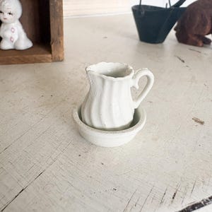 May include: A rustic wooden sign with the text "Welcome to our home" in white lettering. The sign features a distressed finish and a simple, inviting design, perfect for front door decor.