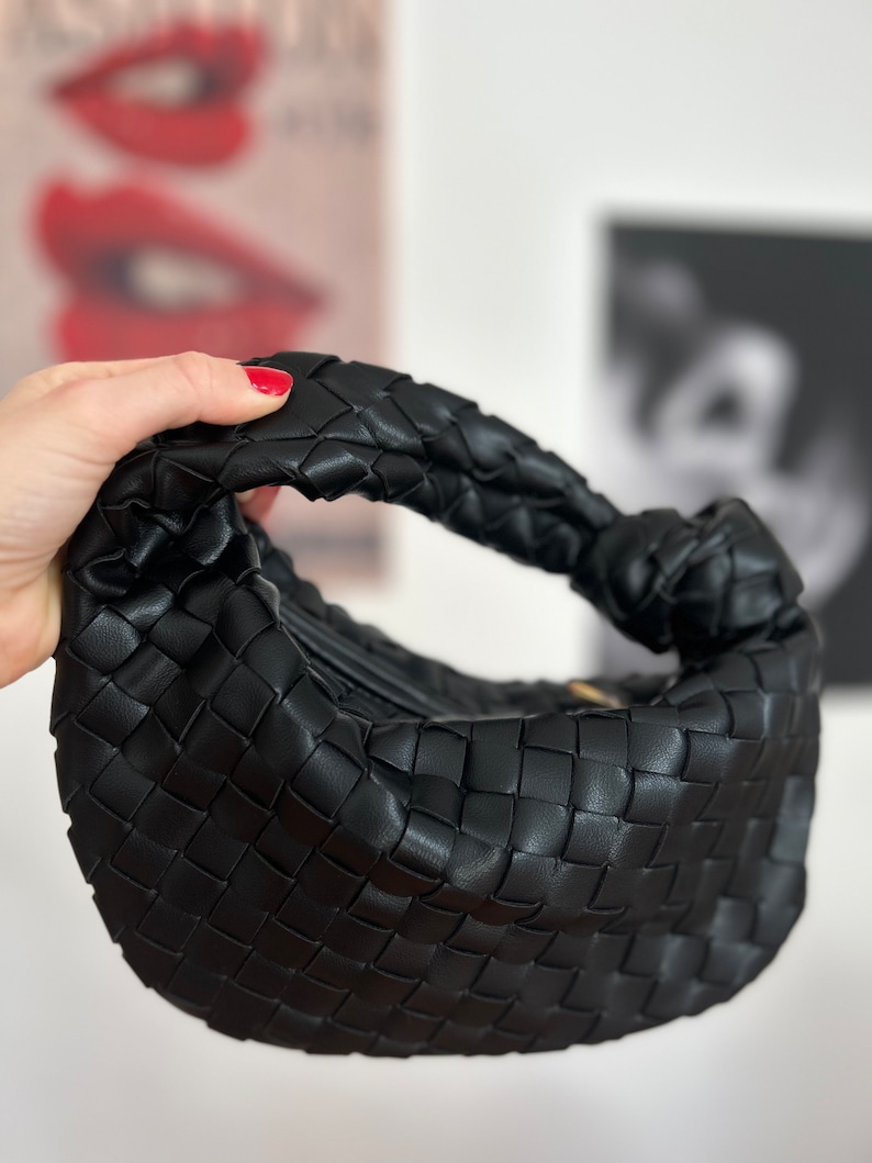 Introducing our stylish and versatile black vegan leather zipper pouch, featuring a unique woven knot design. use it as a makeup bag, clutch. Handcrafted with high-quality vegan leather, this pouch is both cruelty-free and eco-friendly. bottega jodie
