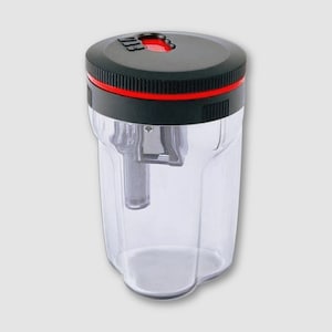 May include: A clear plastic pencil sharpener with a black top and a red accent ring. The sharpener has a transparent body, allowing visibility of the pencil shavings. The design is simple and functional, suitable for office or school use.
